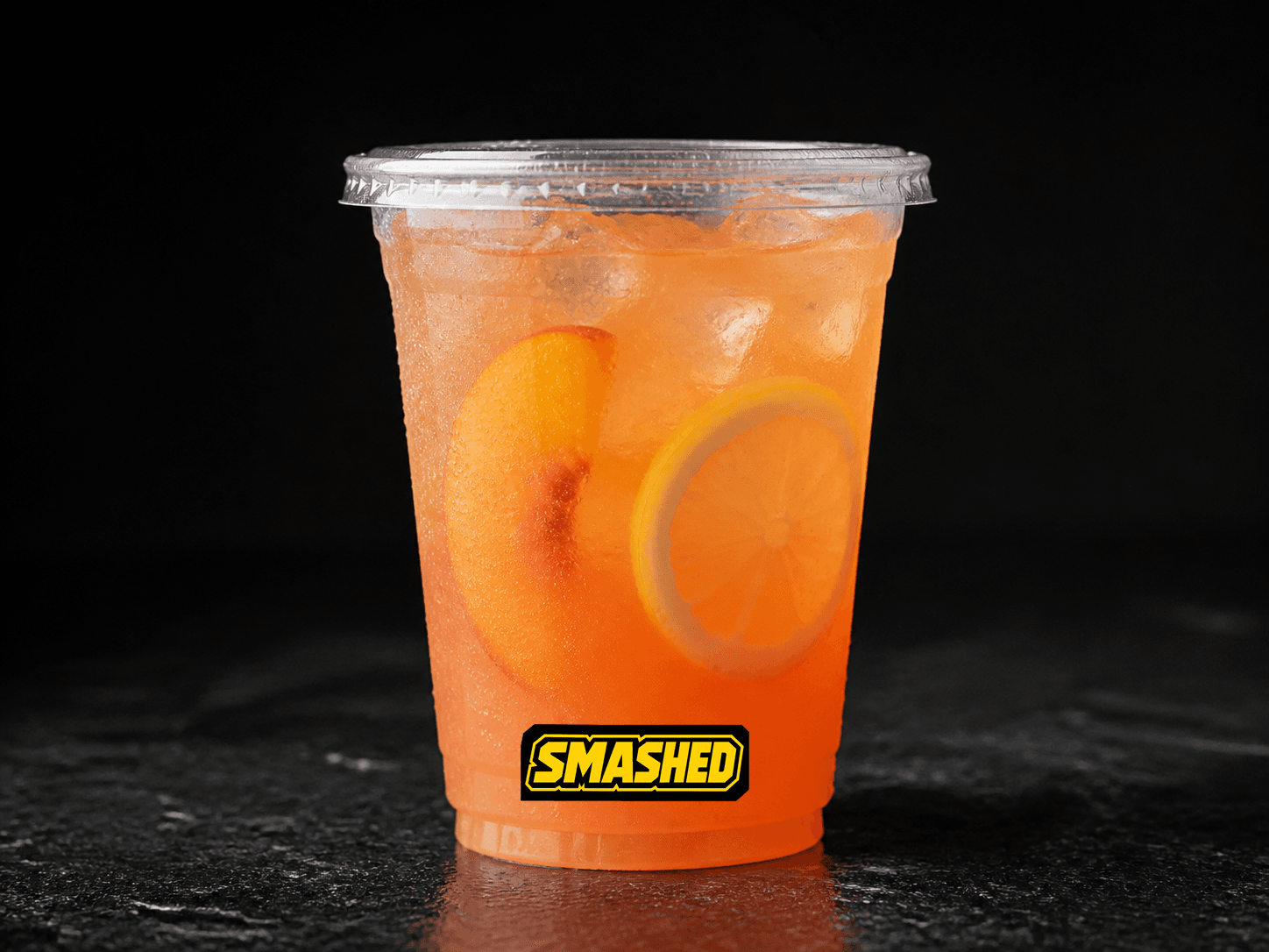 Peach lemonade in a branded clear cup