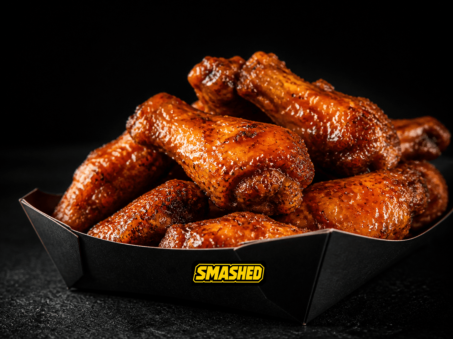 Twenty sauced wings in a black SMASHED box