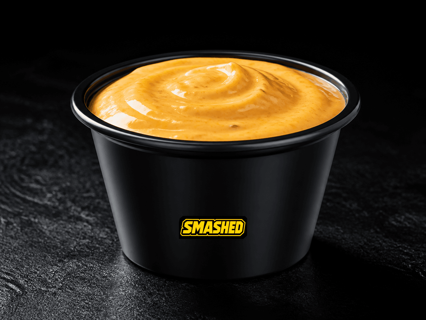 SMASHED Sauce cup on a black counter