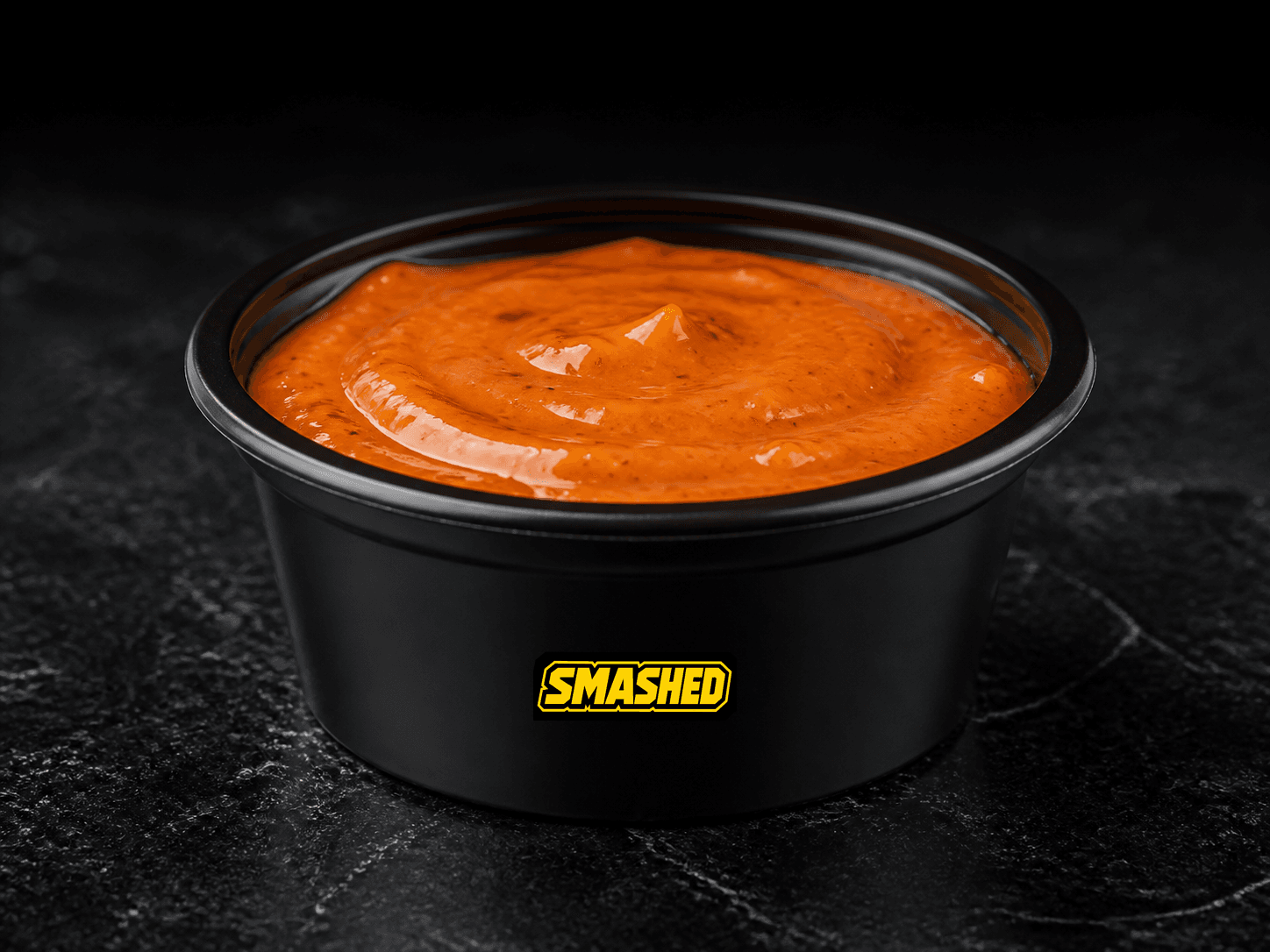 Spicy Street sauce cup on a black counter